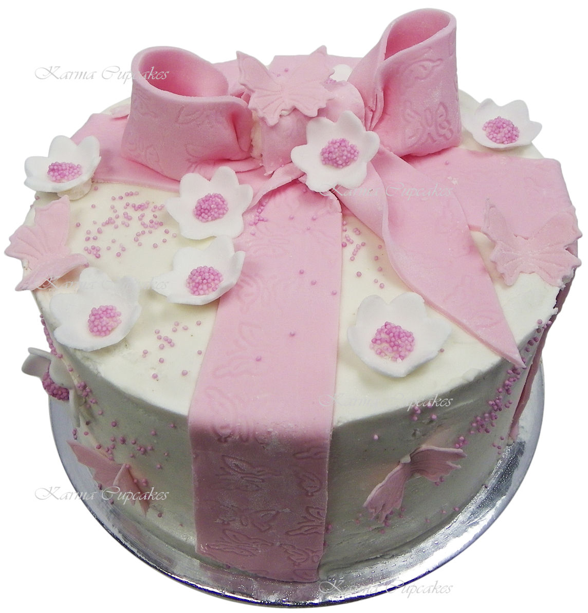 Karma Cupcakes Pink and white cake with edible pink bow and flowers copy