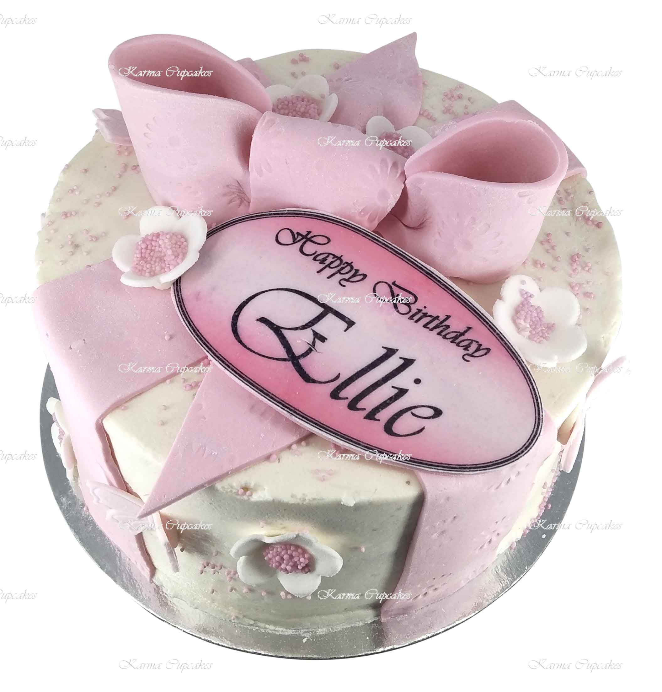 Pink-and-white-ribbon-bow-cake-with-edible-plaque