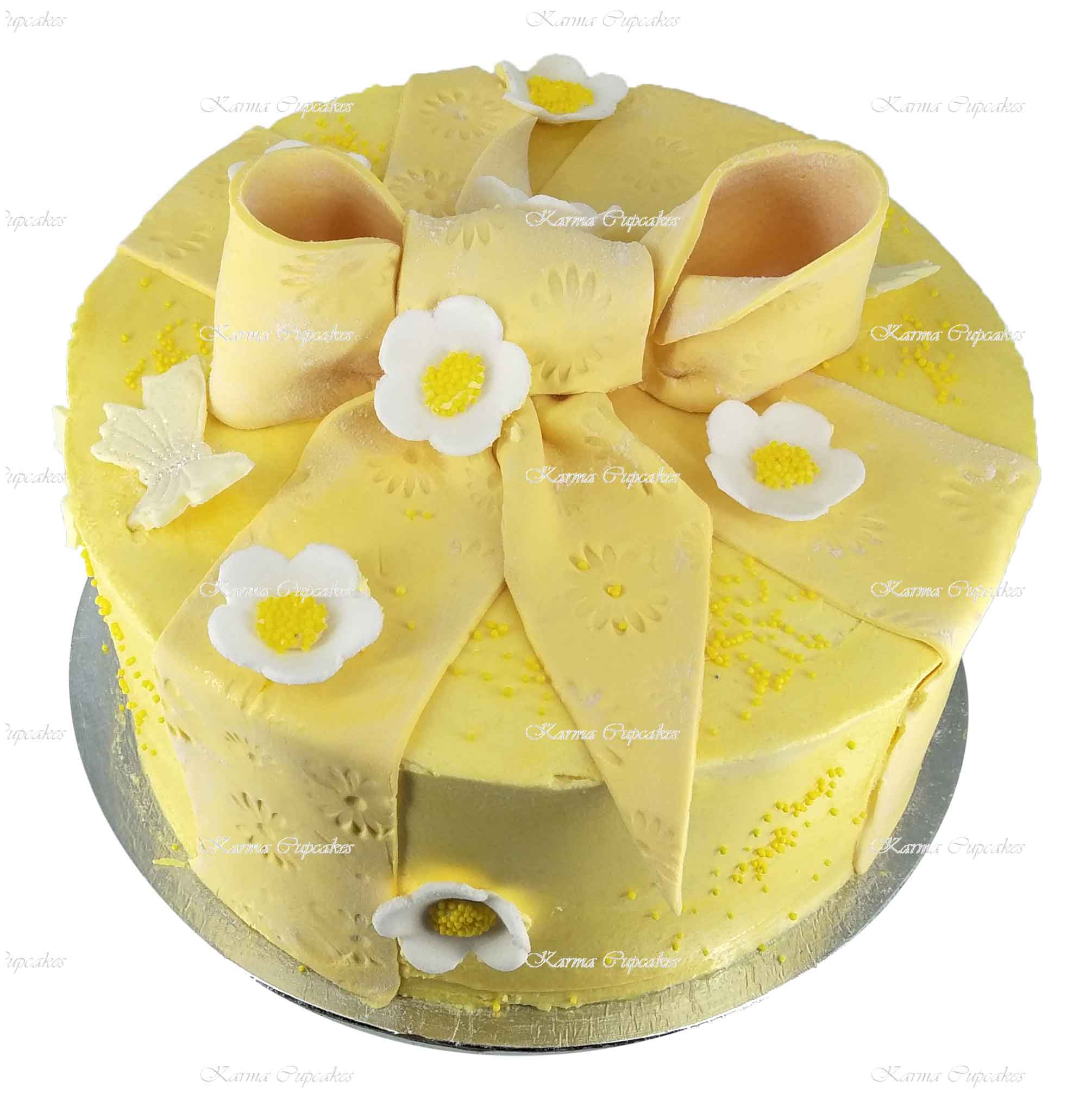Yellow-cake-with-edible-bow-and-flowers