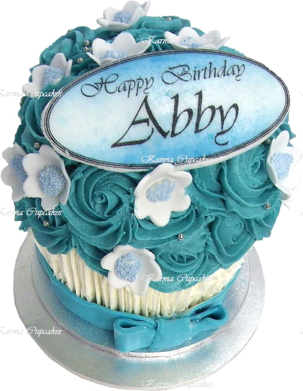 Blue-and-white-giant-birthday-cupcake-with-white-flowers-copy