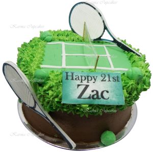 Tennis court cake with edible ball and racquets